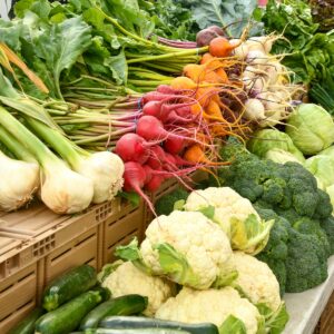 green and red vegetable on brown wooden table