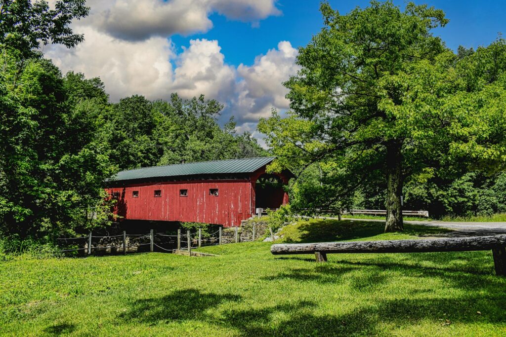 A red barn sits in the middle of a field