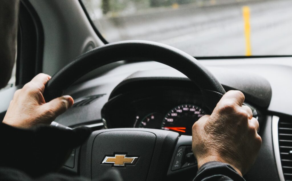 person driving black chevrolet car