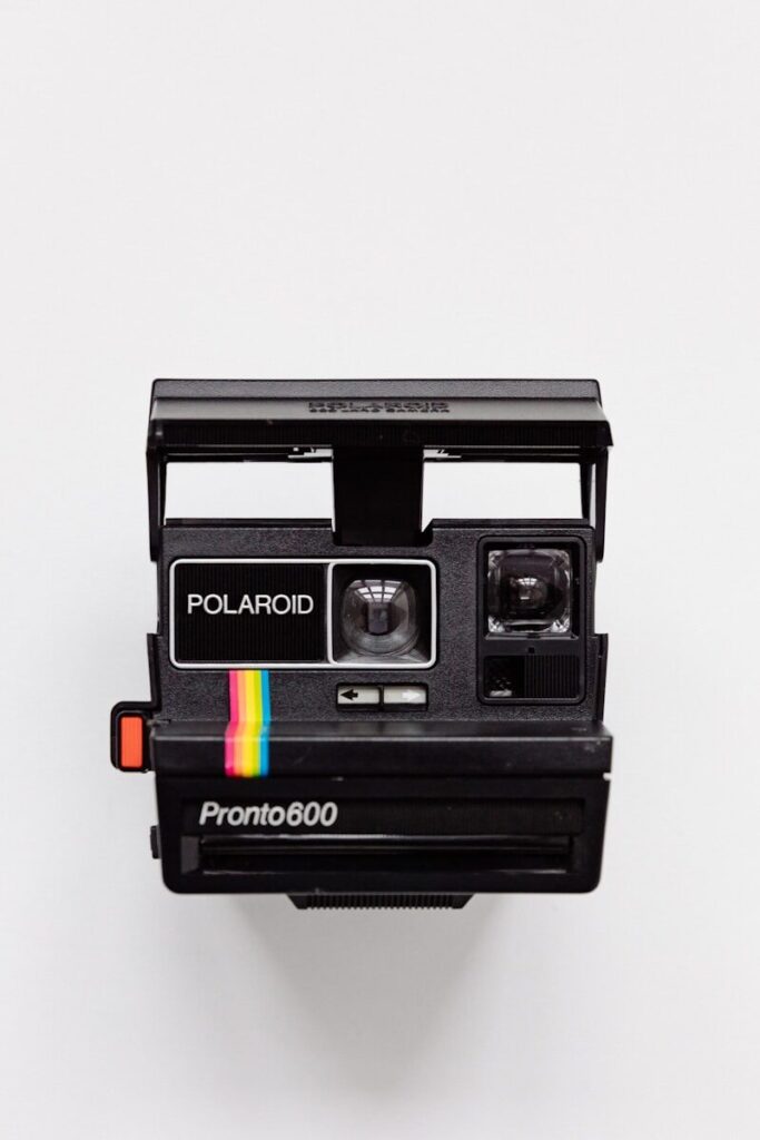 black Polaroid camera with white background